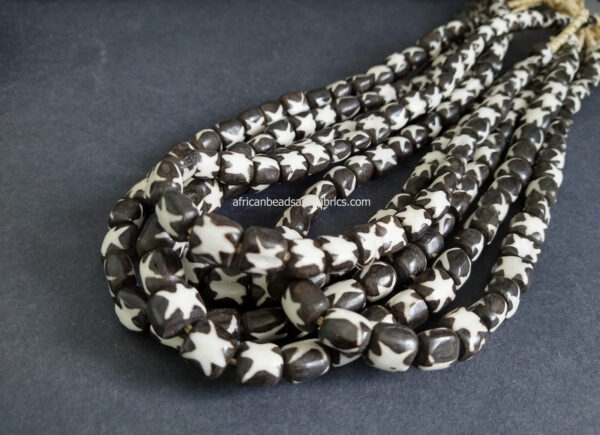 African-Beads-Kenyan-Bone-Medium-tubes-10-to-12-mm-batiked-cream-and-black-stars